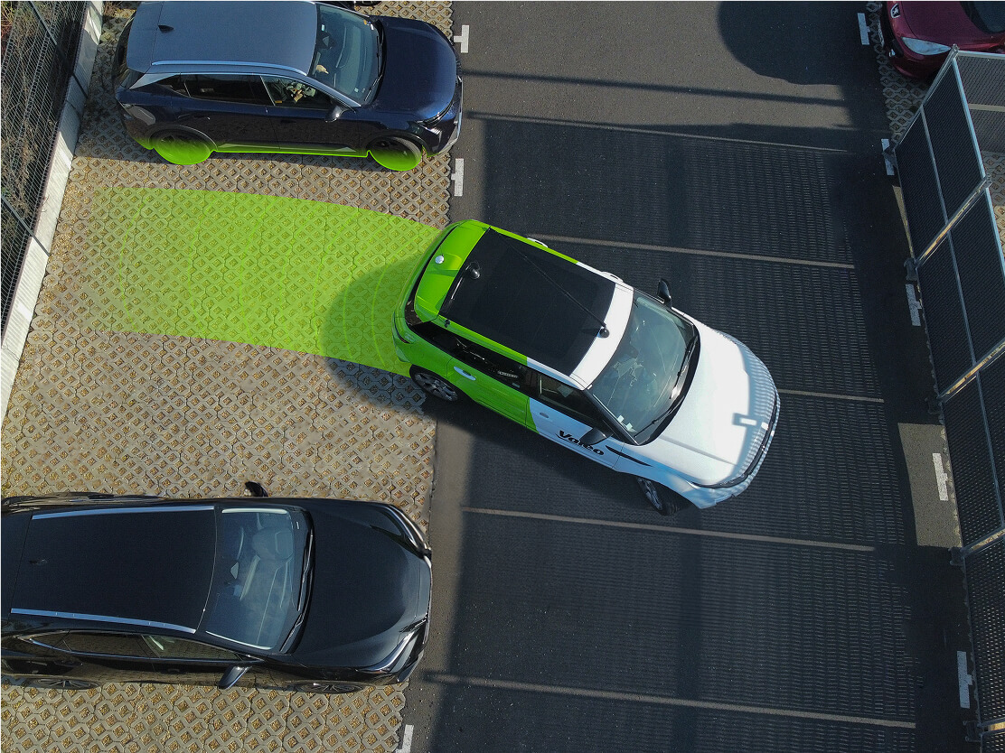 Aerial view of an outdoor parking lot with a car parking