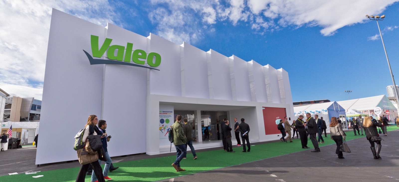A Valeo studio at Consumer Electronics Show 2017 in Las Vegas with attendees walking down the street next to the studio