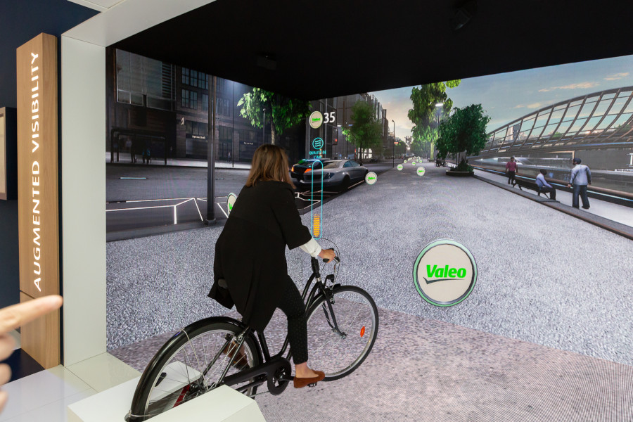 A person testing augmented reality at a Valeo stand at mondial de l auto 2018 event