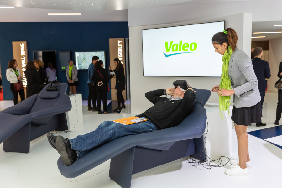 A person testing virtual reality at a Valeo stand at mondial de l auto 2018 event