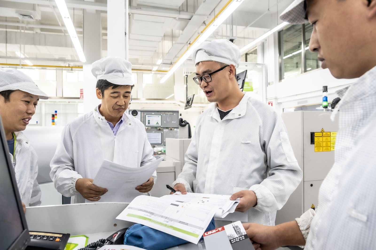 4 men in a meeting in China plant