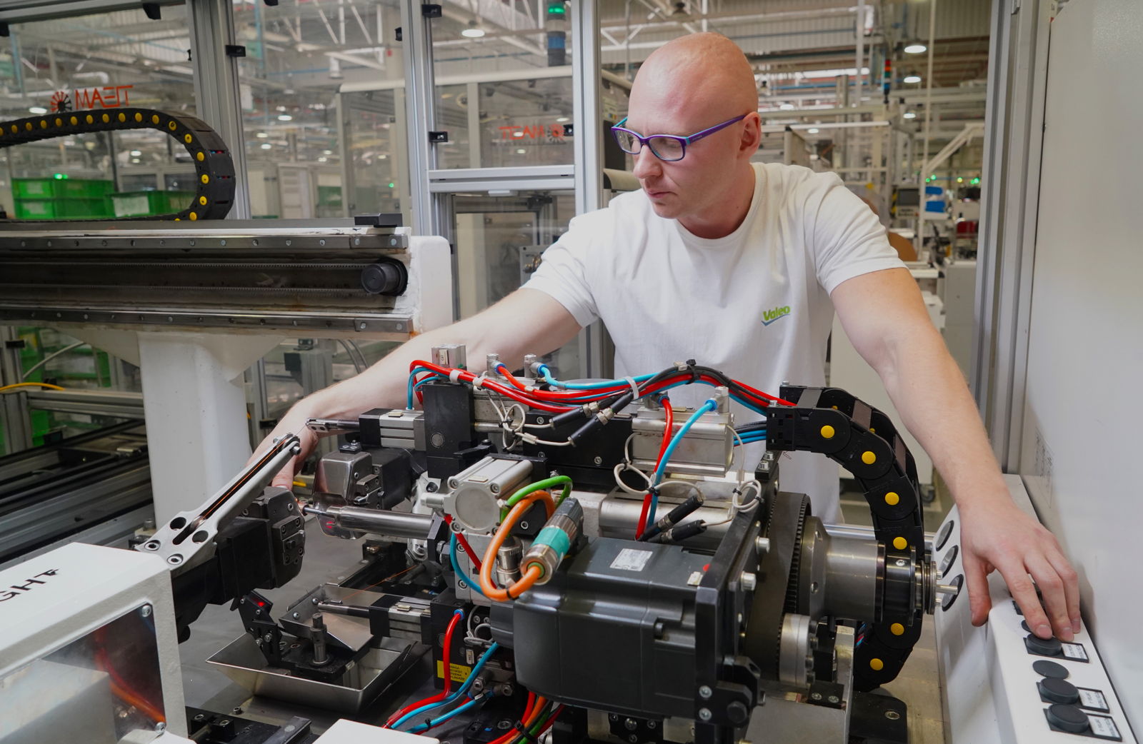 Employee operating a production machine