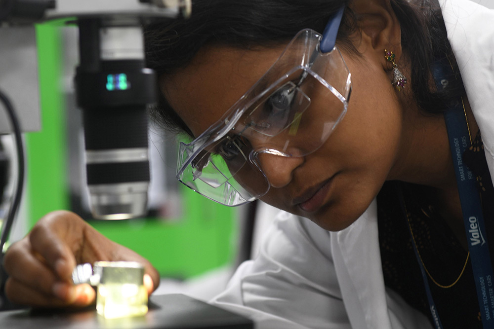 Woman inspecting a product in Valeo India plant Chennai
