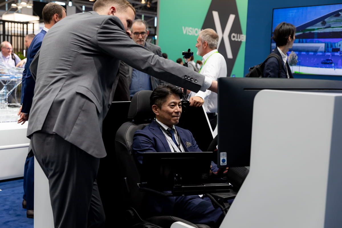 A man tests a driver's cabin on the Valeo stand
